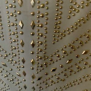 White body suit with gold accents